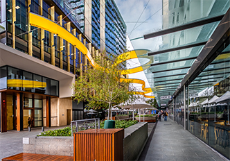 Kings Square entrance with a yellow ribbon showing fire protection works in high-rise towers for fire suppression system installation