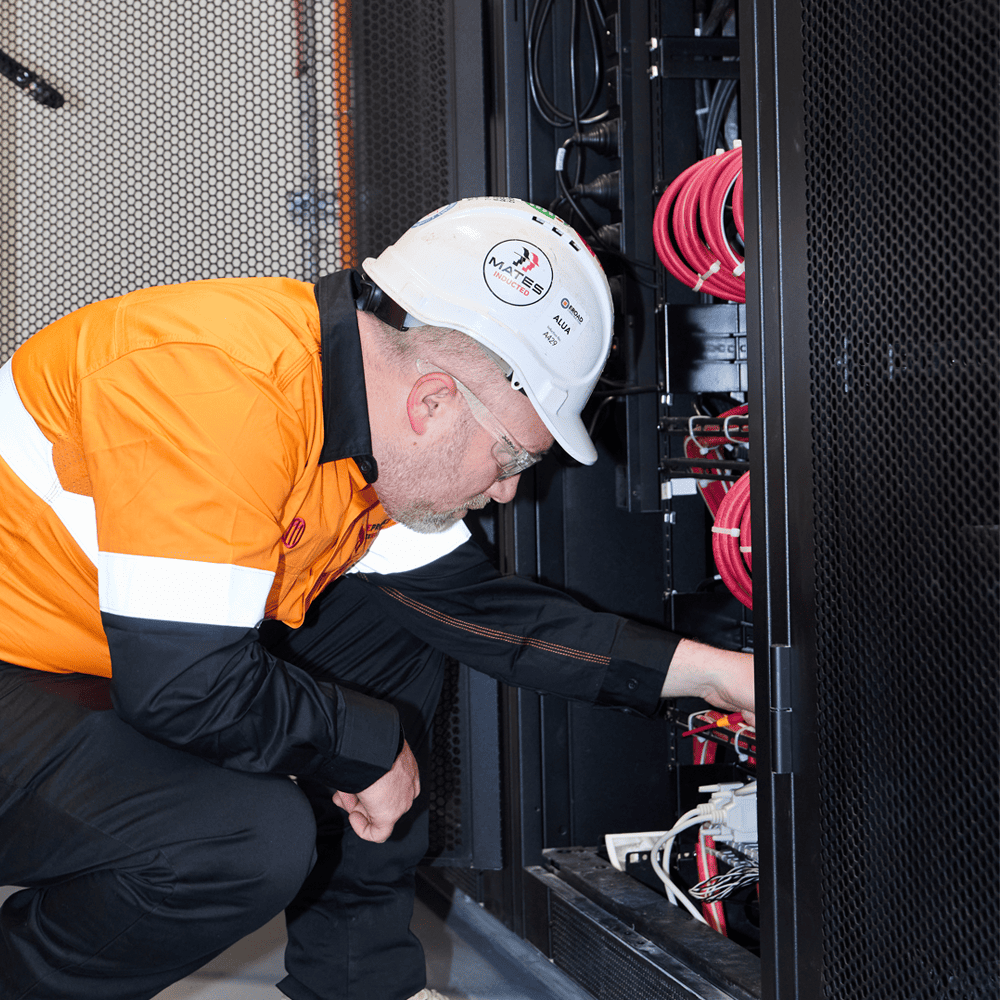 commercial fire alarm systems - Man inspecting a fire alarm system
