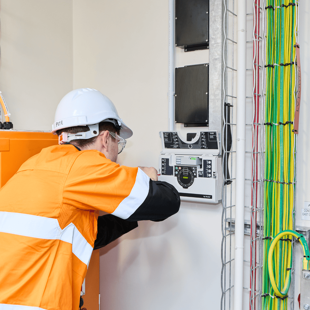fire safety compliance services - man installing a control panel