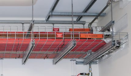 A metal rack displaying red and white wires, associated with Fire Protection Services WA